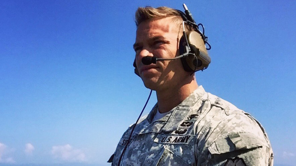 Man wearing headset and US Army fatigues.