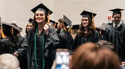 Master of Prosthetics-Orthotics graduate Ann Kramer cheers with excitement at her accomplishment.