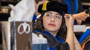Clinical Psychology graduate Jessica Orobio, Ph.D., adjusts her cap as the ceremonies are set to begin.