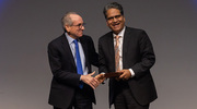 Dr. Podolsky presents Dr. Wakhlu with the Watson Award on stage.