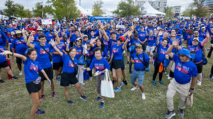 Dozens of participants posing in their blue Heart Walk 2025 t-shirts.