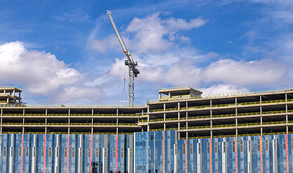 Building under construction with a large crane on top.