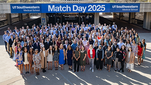 All the matched students gathered outside in front of a banner, UT Southwestern Medical School - Match Day 2025