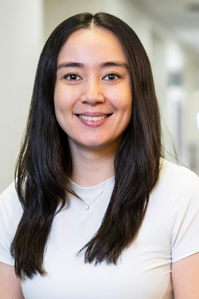 woman with long dark hair and white shirt