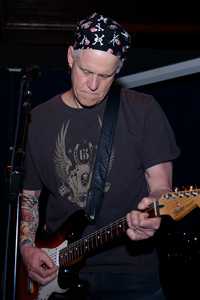 Man playing electric guitar.
