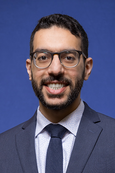 headshot of man with dark hair, glasses and beard