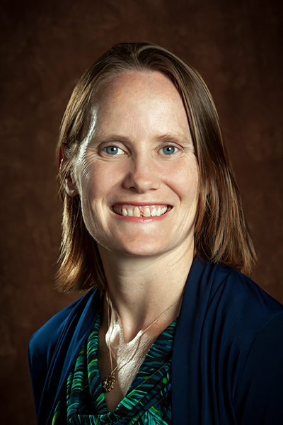 headshot of blond woman in black shirt