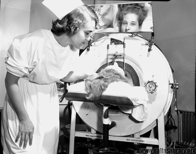 Nurse attending to a woman in Iron Lung at Parkland in 1951