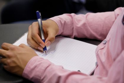 person writing in a notebook