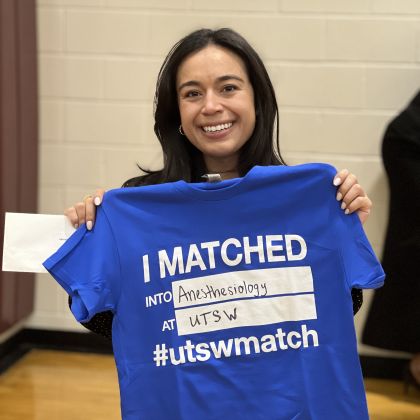 Briana Alvarado, M.D. holding shirt which reads I matched at UTSW in anesthesiology
