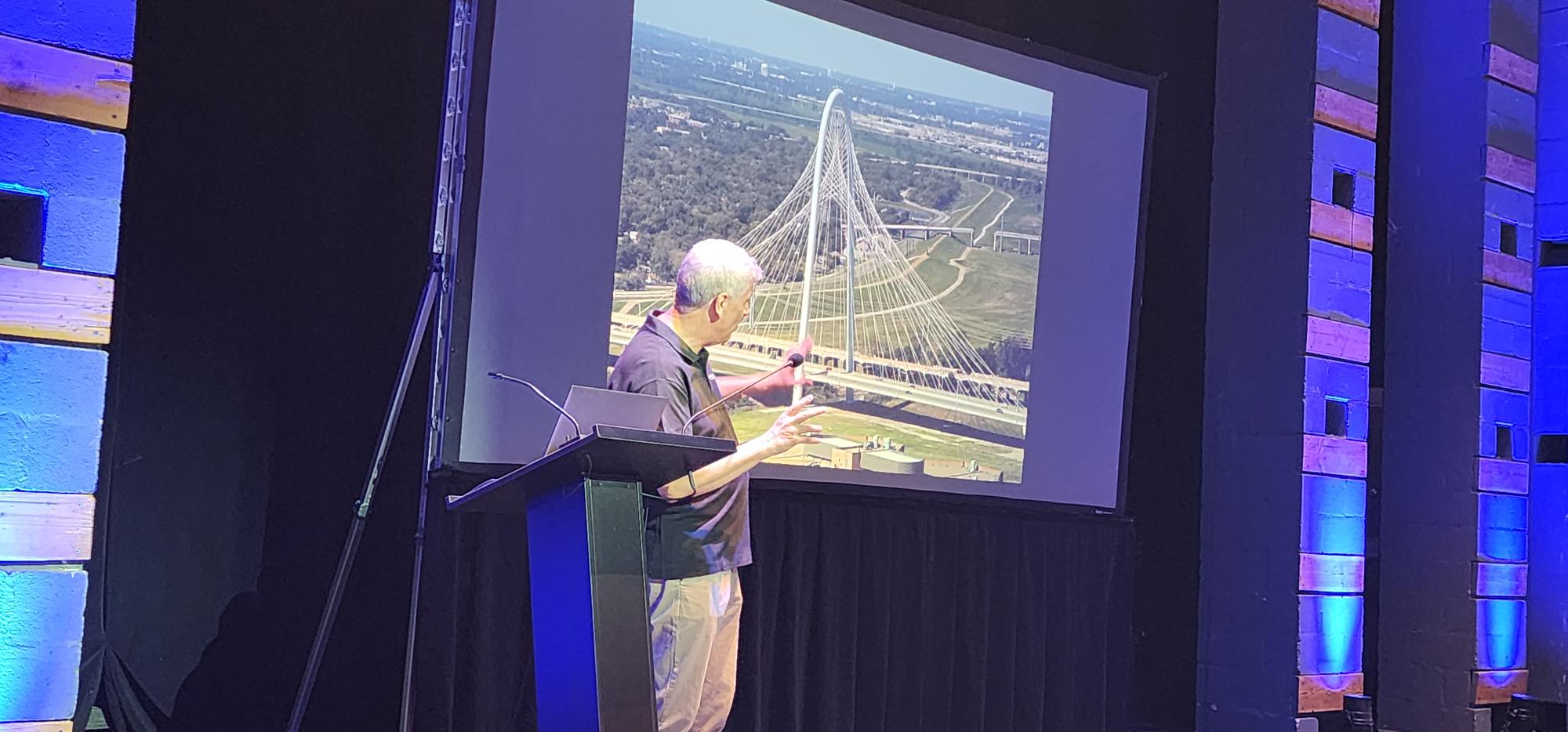 Our Inaugural Chair, Dr. Gaudenz Danuser, pointing to a picture of the Hill Bridge in Dallas