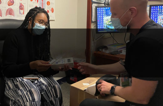 patient holding a blood glucose meter