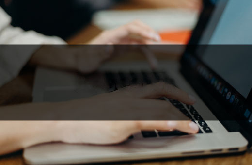 person typing on a laptop