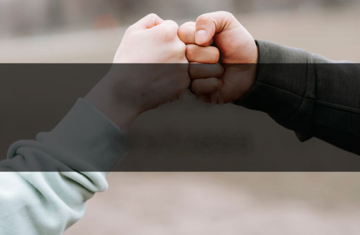 child fist bumping with an adult