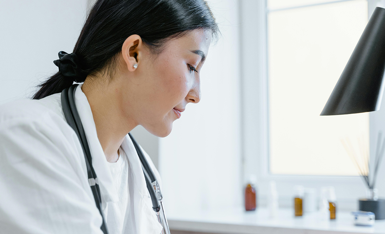 A closeup of a female doctor's face in profile