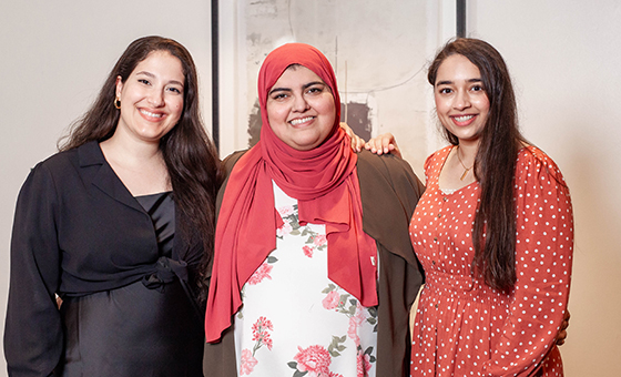 3 women standing in front of white wall