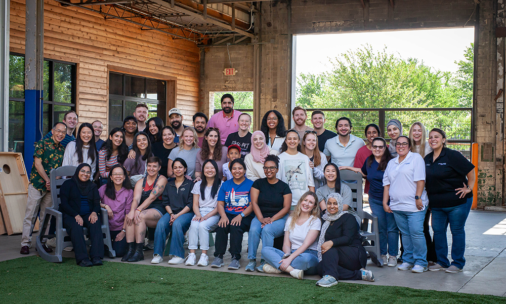 A group photo of the current residents on an outdoor ptio, taken on a residency retreat