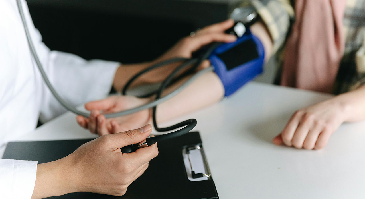 Physician checks patients blood pressure