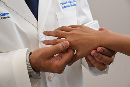 Doctor examining patient's hand