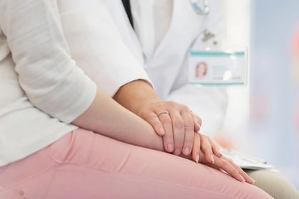 patient talking to doctor in exam room