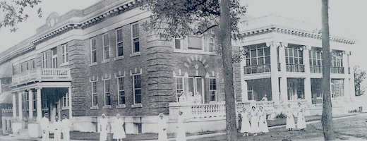 A black and white photo of the old Parkland Hospital, as described in the caption