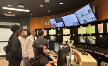 physicians and staff looking at a group of monitors