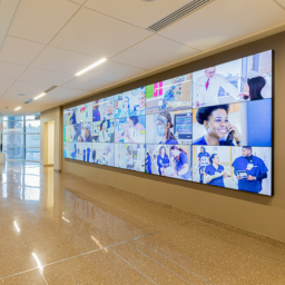 A hallway decorated with a large mural showing a photocollage of the multidisciplinary team at work