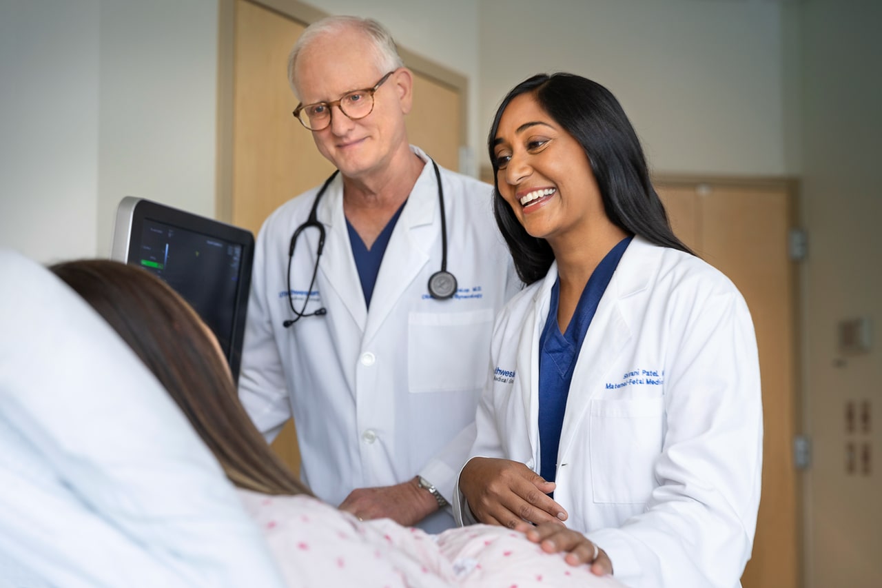 two doctors at a patient's bedside