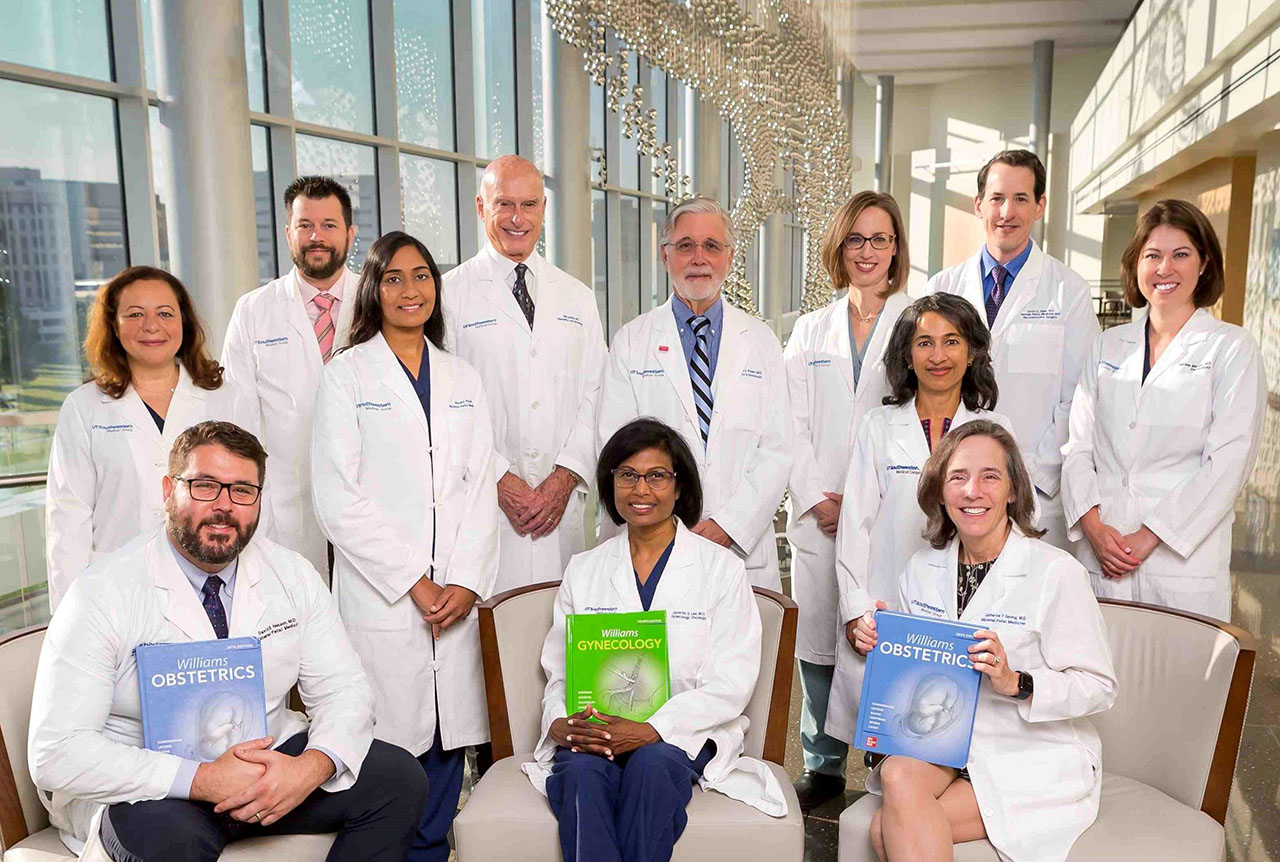 A group of UTSW faculty. The faculty members seated at the front are holding copies of Williams Obstetrics and Williams Gynecology