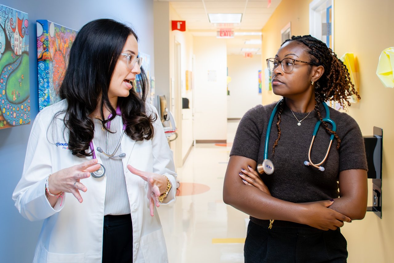 Dr. Zomer walking down the hall, interacting with a resident