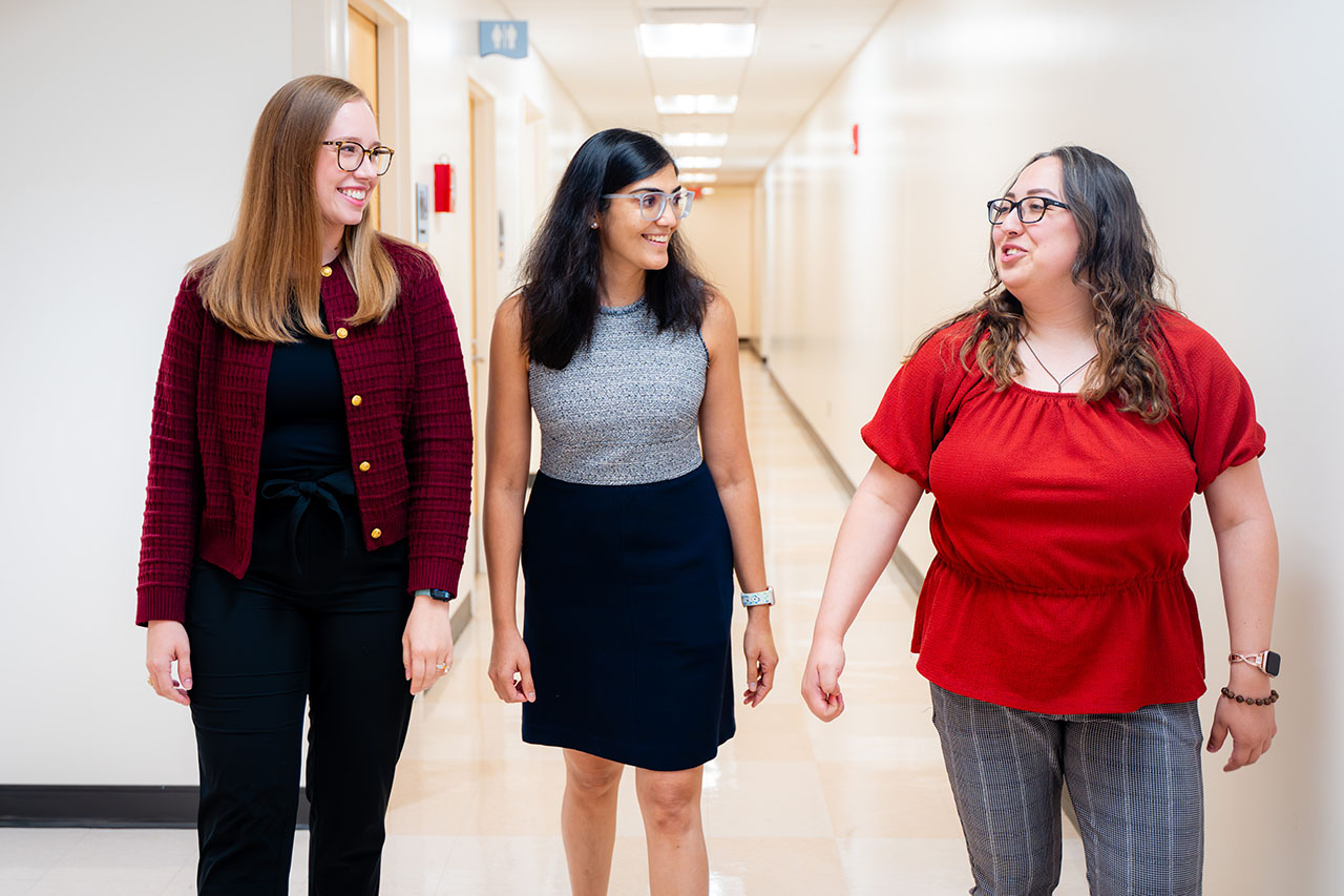 Dr. Patni walking down a hallway with two fellows