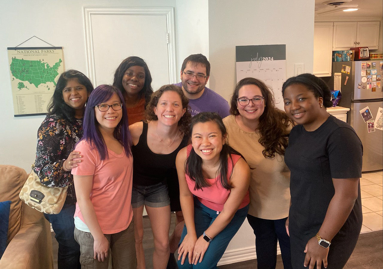 A casual group shot of the Fellows in an apartment