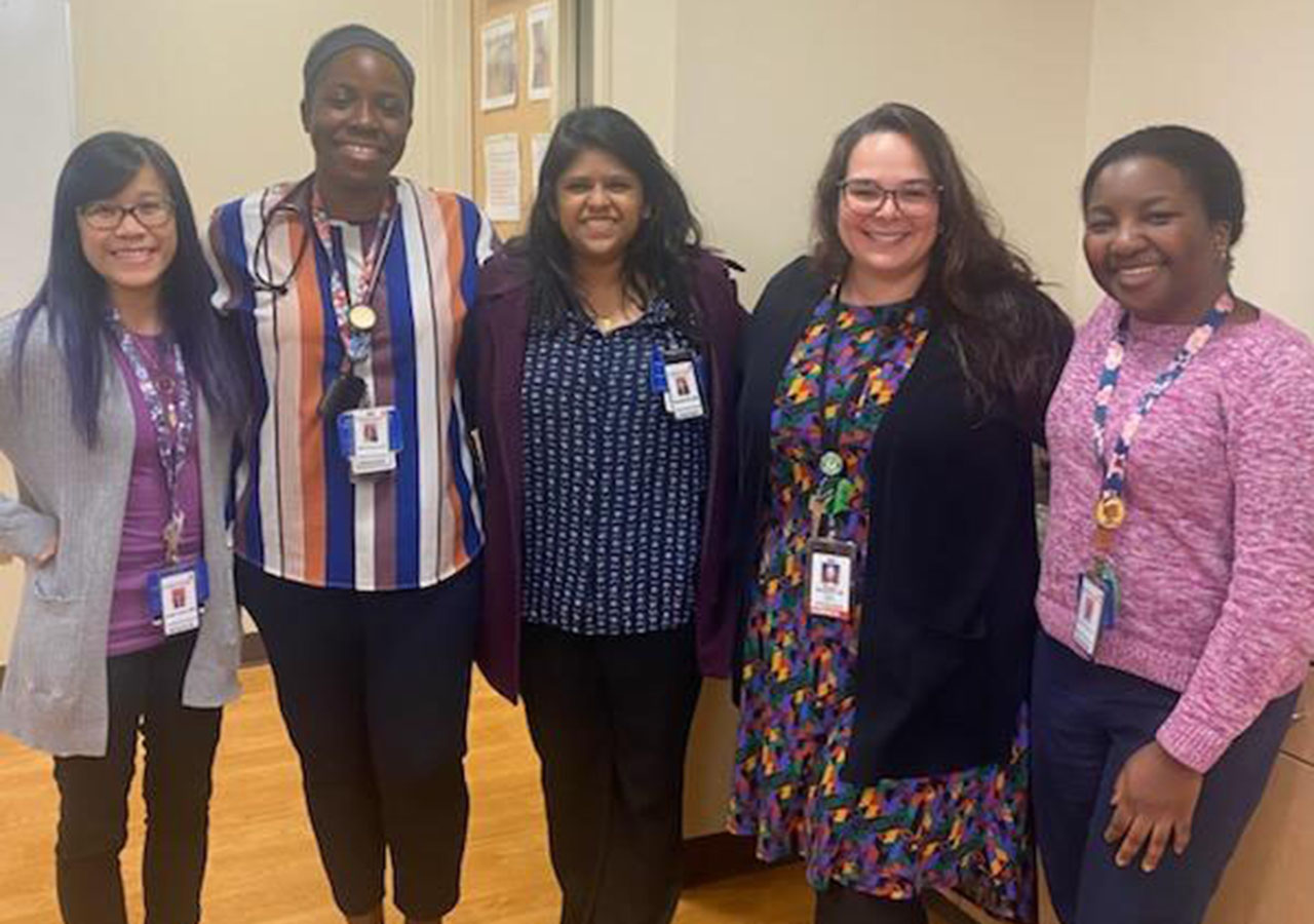 A group shot of the Fellows in a professional setting wearing name badges