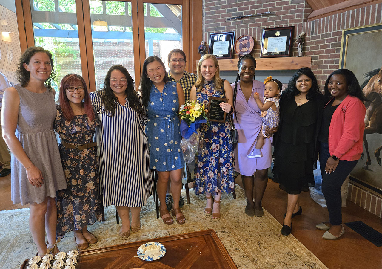 A group shot of the Fellows at a party with cupcakes in the foreground
