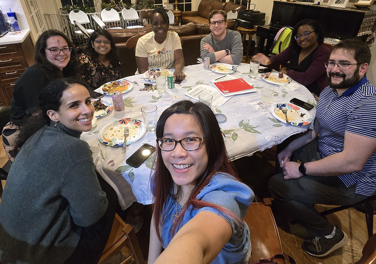 A selfie shot of the Fellows eating at a table