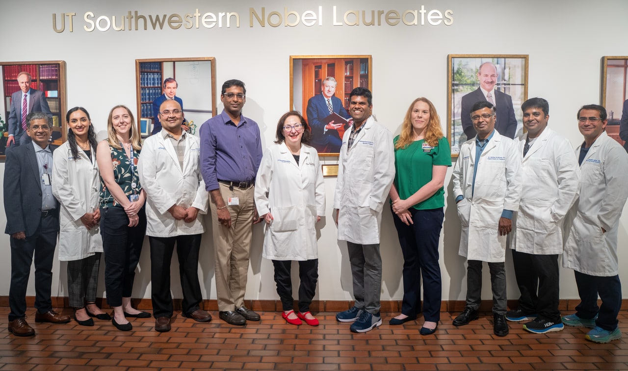 neonatology team in front of pictures of past Nobel Laureates