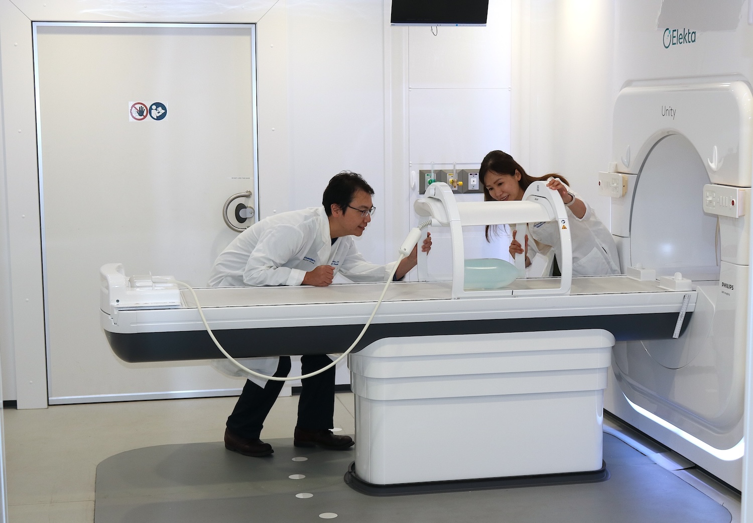 Fellow with physicist testing on Unity treatment machine