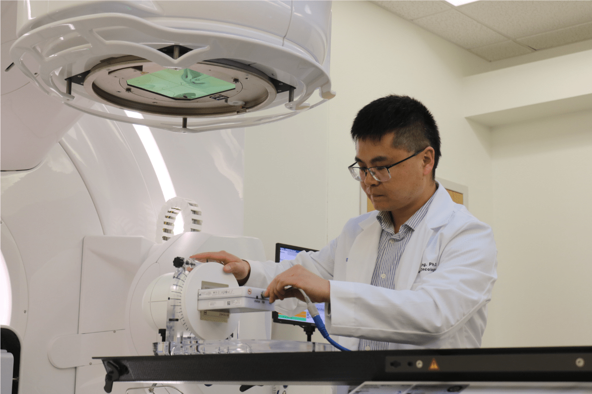 Man in white lab coat operating Evo equipment.