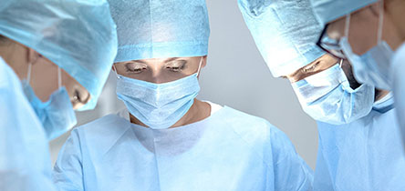 three surgeons in masks