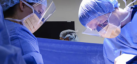 three surgeons in masks