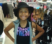 Aolani wearing a hat and with a big smile