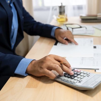 a person works on a calculator
