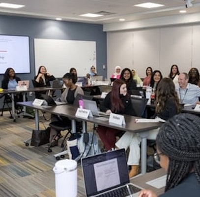 classroom full of people seated at desks