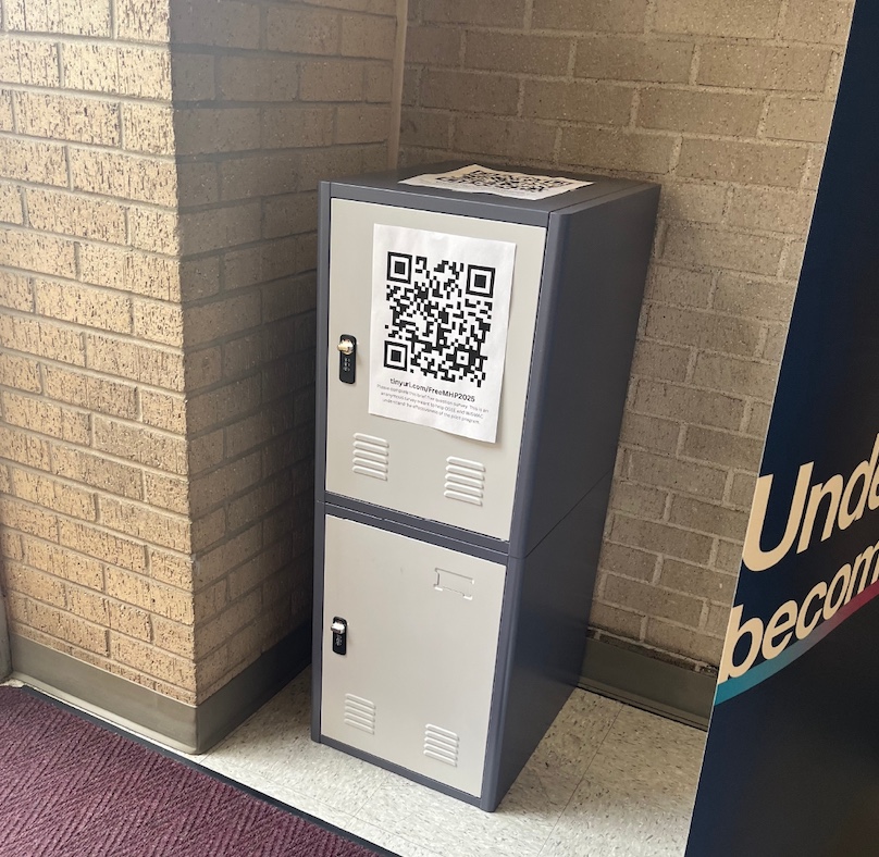 A dark grey locker with two light grey doors. A large QR code displayed on the top door.