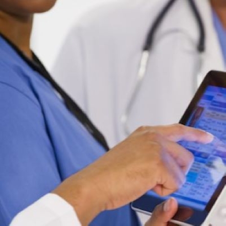 a person's hand taps on a tablet