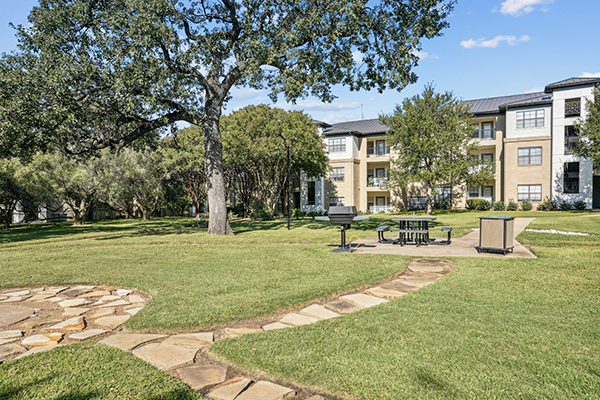 Apartment Building and Courtyard with Picnic Table and Grill
