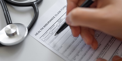 Woman filling Health Insurance claim form