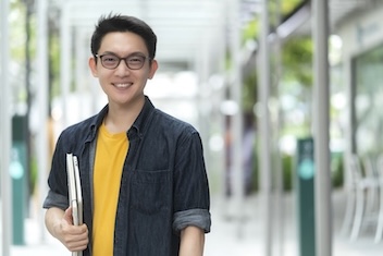 a young adult student holding folder