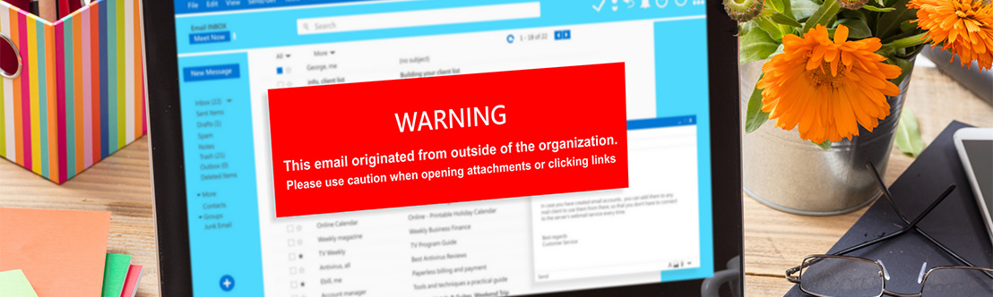 A photo of a laptop screen displaying a red warning that says: Warning! This email originated from outside of the organization