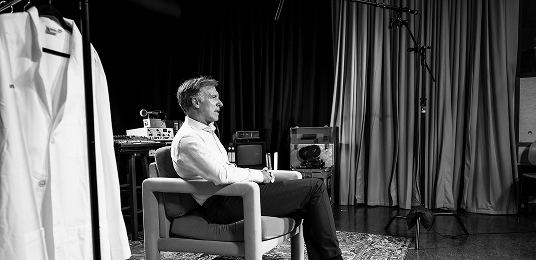 Dr. Hommes sitting in a chair while getting interviewed 